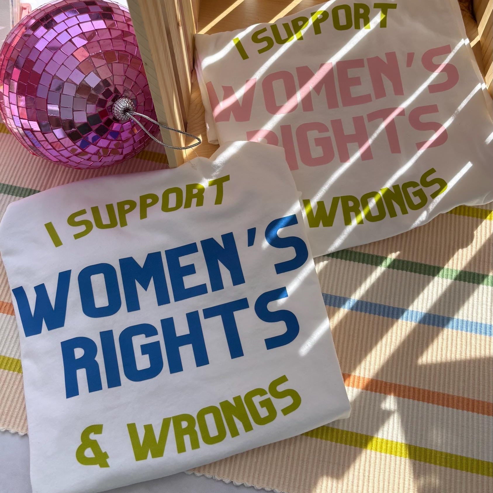 Small sign with 'I Support Women's Rights & Wrongs' text on a colorful background